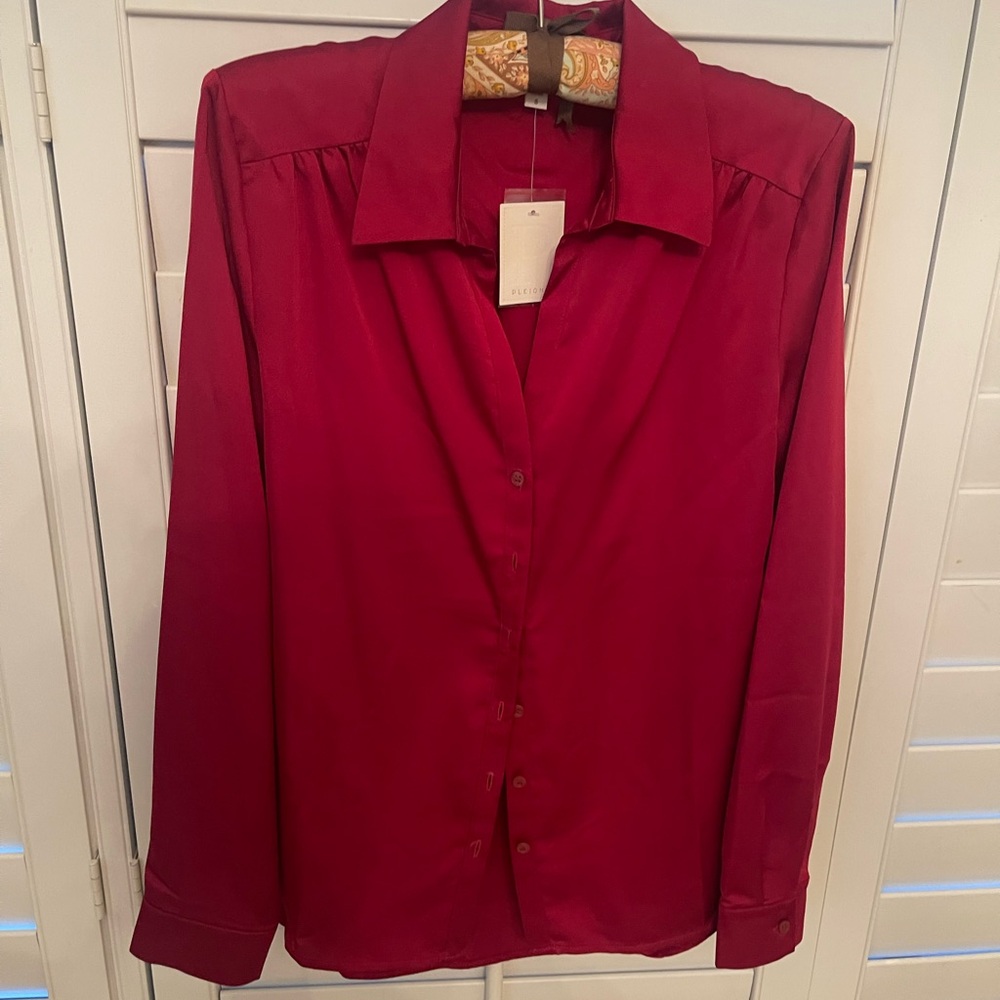 Just in time for the holidays! Beautiful red satiny top.